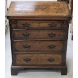 A 19th century style mahogany inlaid four-drawer chest of drawers with a fold-out top,
