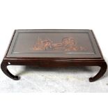 An early/mid-20th century Japanese hardwood coffee table with figural and scenic decoration to the