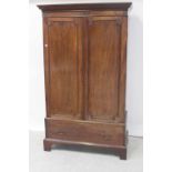 A 19th century mahogany linen press, stepped and fluted frieze over twin panelled doors,