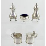 A pair of hallmarked silver peppers, two silver mustard pots and a salt, various hallmarks,