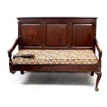 A George III oak bench settle,