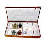 A case containing five Chinese snuff bottles to include glass, ceramic,