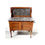 A Victorian mahogany wash stand with marble splash back and top, to two doors,