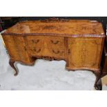 An early/mid-20th century walnut Epstein-style serpentine-front sideboard,