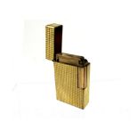 A vintage Dupont, France yellow metal engine-turned cigarette lighter with 'S Dupont Paris,