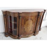 A Victorian Aesthetic period burr walnut serpentine credenza with shaped glass cupboards enclosing