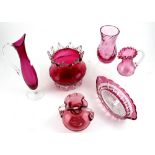 A group of six pieces of early 20th century and later cranberry and cranberry-coloured glassware to