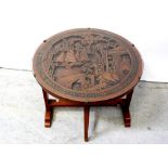 An early/mid-20th century circular Japanese circular tilt-top occasional table with carved figural