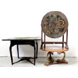 An early/mid-20th century Japanese circular tilt-top table with raised carved figural and village