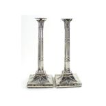 A pair of George III hallmarked silver candlesticks of Corinthian column form with leaf decoration