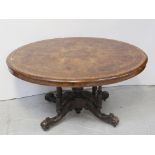 A 19th century walnut oval tilt-top table, scroll and foliate inlay,