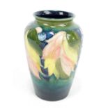 MOORCROFT; a 'Leaf and Berry' pattern tubeline decorated vase, WM monogram and impressed signature