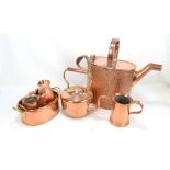 A large late Victorian beaten copper watering can, a copper kettle (lacking finial), and a small