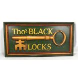A large locksmith's wooden sign, moulded with a key inscribed 'Thos. Black Locks', 50 x 104cm.