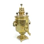 A late 19th century brass samovar with Cyrillic stamps and dates 1891, 1896 and 1897 to front,