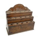 An early 19th century oak three section stepped spoon rack with arched back plate, width 36cm.