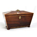 A Victorian mahogany inlaid sarcophagus tea caddy with bun feet, length 28cm.Additional