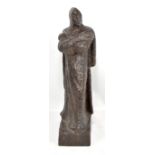 A late 19th century carved and adzed wooden carving of a cloaked figure, possibly Mephisto,