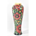 MOORCROFT; a floral tube line decorated slender baluster vase, impressed marks and year cipher for