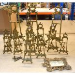 A group of brass foliate scroll pierced decorated easels, all varying in sizes, the tallest 52cm.