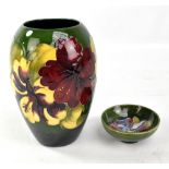 MOORCROFT; an 'Hibiscus' pattern tubeline decorated vase on green and turquoise ground, WM