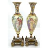 A pair of late 19th century brass, porcelain and champlevé enamel decorated vases, each ovoid body