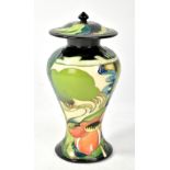 MOORCROFT; a tube line decorated lidded vase featuring stylised landscape and leaves to lid,