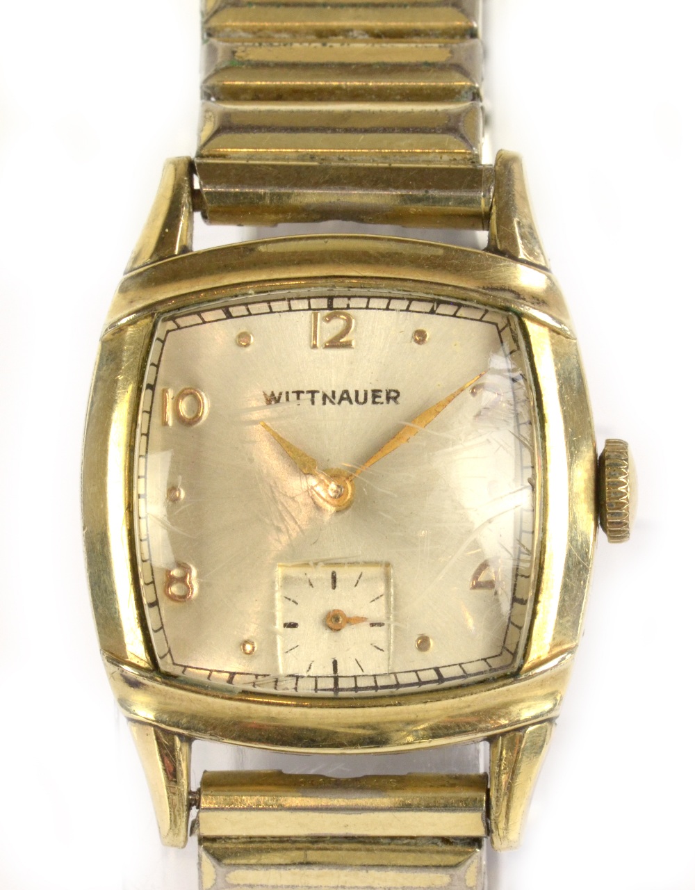 LONGINES-WITTNAUER; a 1940s wristwatch with Arabic and gold dot markers to the shaped dial, with