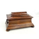 A Victorian rosewood sarcophagus form tea caddy with three section interior including glass bowl