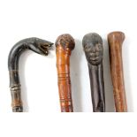 Seven walking sticks of varied size and form, three with carved detail and one fashioned from horn