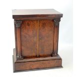 A mid-19th century burr walnut collectors' cabinet, the twin doors set with Ionic columns, with