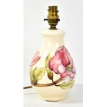 MOORCROFT; a tubeline decorated 'Magnolia' pattern baluster lamp base on cream ground, impressed