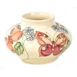 MOORCROFT; a tube line decorated 'Butterfly' pattern squat vase on cream ground, WM monogram with