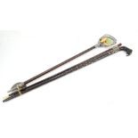 A Gamebird shooting stick, with numerous vintage members badges tied to the handle, a walking cane