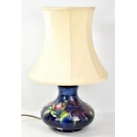 MOORCROFT; a tubeline decorated 'Anemone' pattern squat lamp base on blue ground, impressed marks