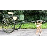 A Whitechapel-style rustic dog cart with a tan leather button back support and seat, repainted in