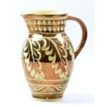 GORDON FORSYTH (1879-1952); a white earthenware jug, copper lustre oak leaf decoration on honey