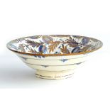 GORDON FORSYTH (1879-1952); a white earthenware bowl, copper lustre fleur de lis decoration on