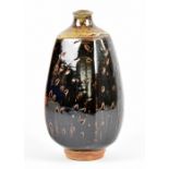 MARK GRIFFITHS (born 1956); a square stoneware bottle, tenmoku and kaki glaze with green ash top and