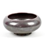 BERNARD LEACH (1887-1979) for Leach Pottery; an early stoneware footed bowl covered in metallic