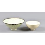 PETER WILLS (born 1955); a porcelain footed bowl covered in mottled lime green glaze with bronze