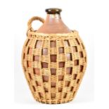 Muchelney Pottery; a large stoneware flagon in a basket, impressed pottery mark, height 41.5cm.