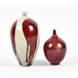 BRIDGET DRAKEFORD (born 1946); two porcelain bottles covered in copper red and celadon glaze,