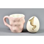 ALISON BORTHWICK; a slip cast porcelain egg, painted AB mark and dated 1985, height 9.5cm, and a