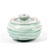 ALEX SHIMWELL (born 1980); a textured porcelain jar and cover covered in celadon glaze, impressed