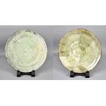 AKIKO HIRAI (born 1970); a near pair of stoneware plates covered in green ash glaze, painted mark to