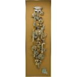 BOWEN WILLIAMS; an abstract wall plaque depicting South American masks and artifacts on a hessian