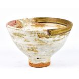 ROBIN WELCH (born 1936); a stoneware pedestal bowl covered in white glaze with gold and red rim,