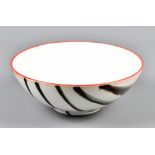 ROMILLY GRAHAM; a porcelain bowl, linear decoration on white ground with Venetian red rim, painted