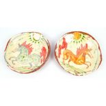 BEN FOSKER (born 1960); a near pair of slip decorated earthenware dishes depicting horses, largest